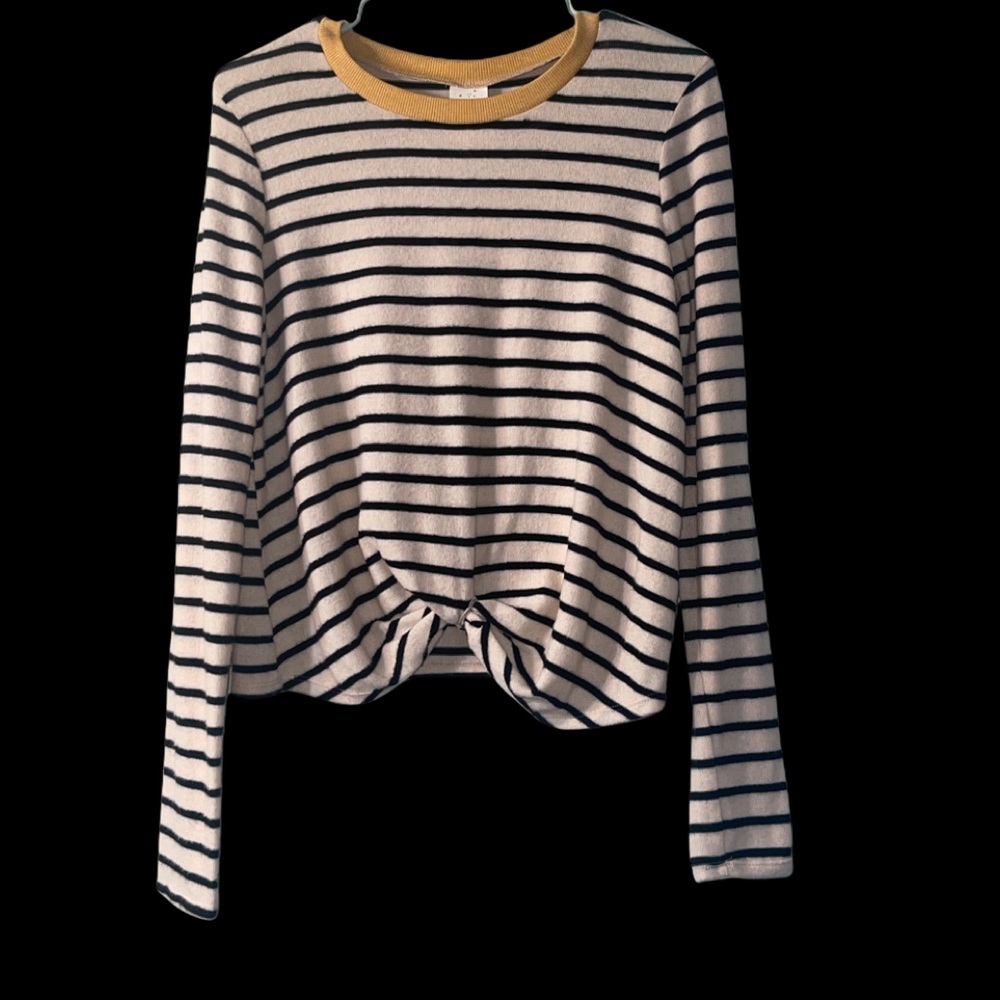 Creme sweater with black stripes with twist in front hem line